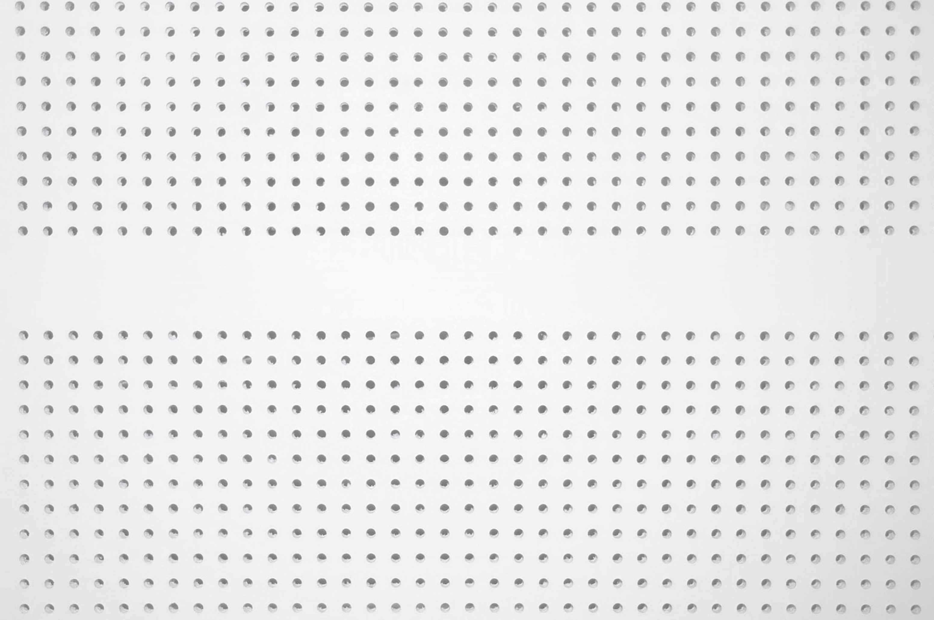 A white perforated metal panel with evenly spaced round holes arranged in horizontal rows, creating a uniform geometric pattern across the surface.