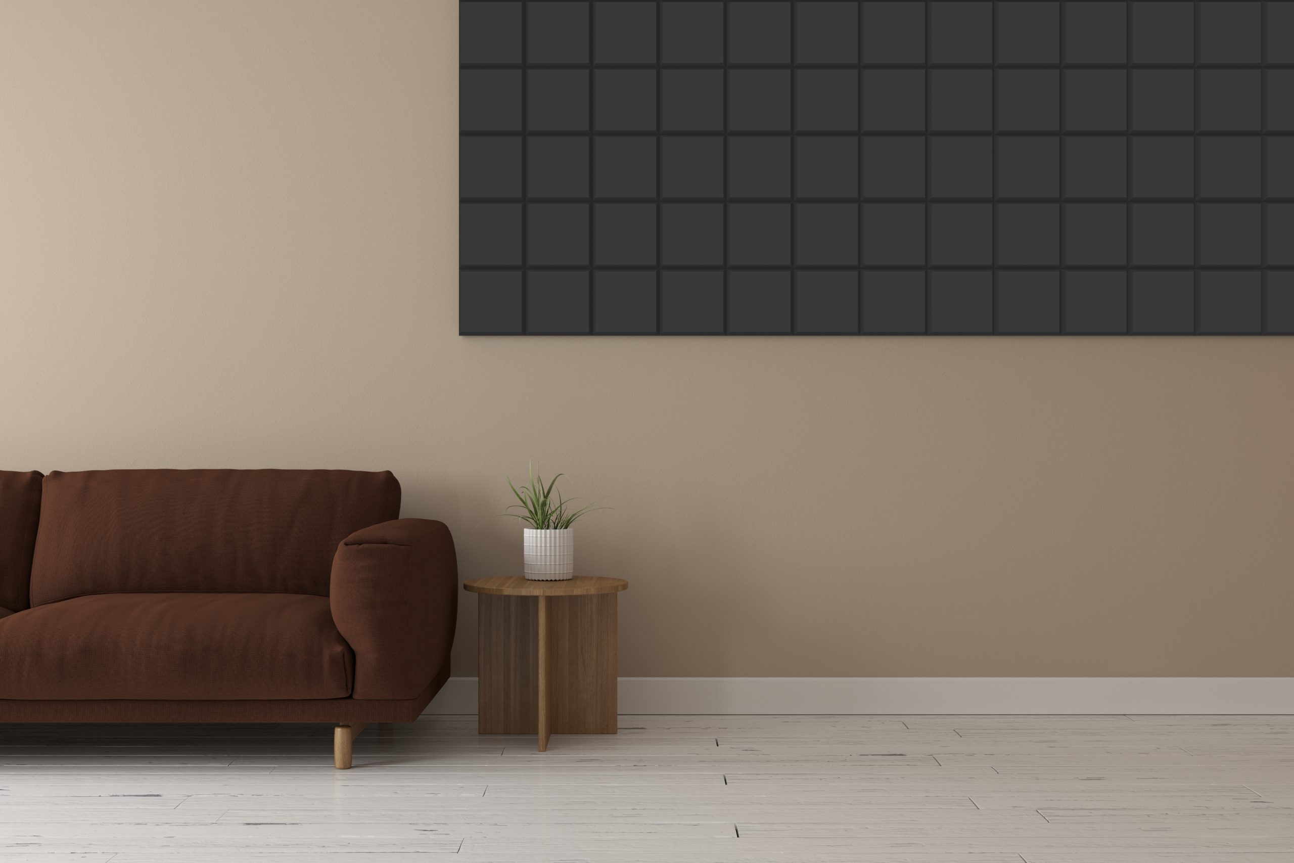 A brown sofa and small wooden side table with a potted plant sit against a beige wall, which features a large grid-patterned black artwork. White wooden floor completes the minimalist living room decor.