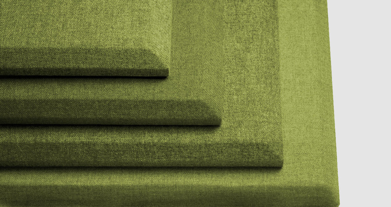 Four green, rectangular, fabric-covered acoustic panels are stacked on top of each other in decreasing size, creating a stepped pattern against a light gray background.