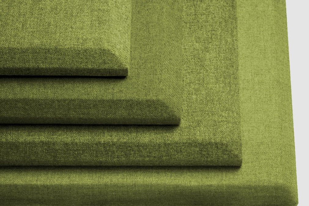 Four green, rectangular, fabric-covered acoustic panels are stacked on top of each other in decreasing size, creating a stepped pattern against a light gray background.