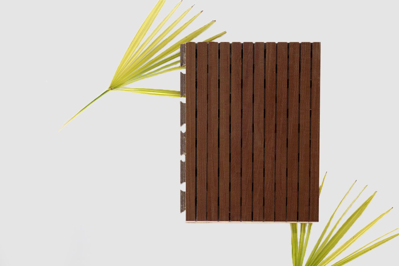 A rectangular wooden slat panel is placed vertically on a white background, with two green palm leaves partially visible on the left and bottom right sides of the image.