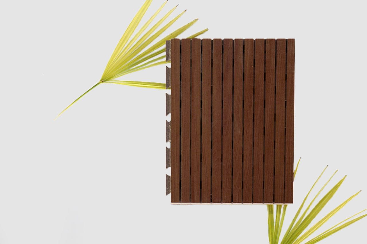 A rectangular wooden slat panel is placed vertically on a white background, with two green palm leaves partially visible on the left and bottom right sides of the image.