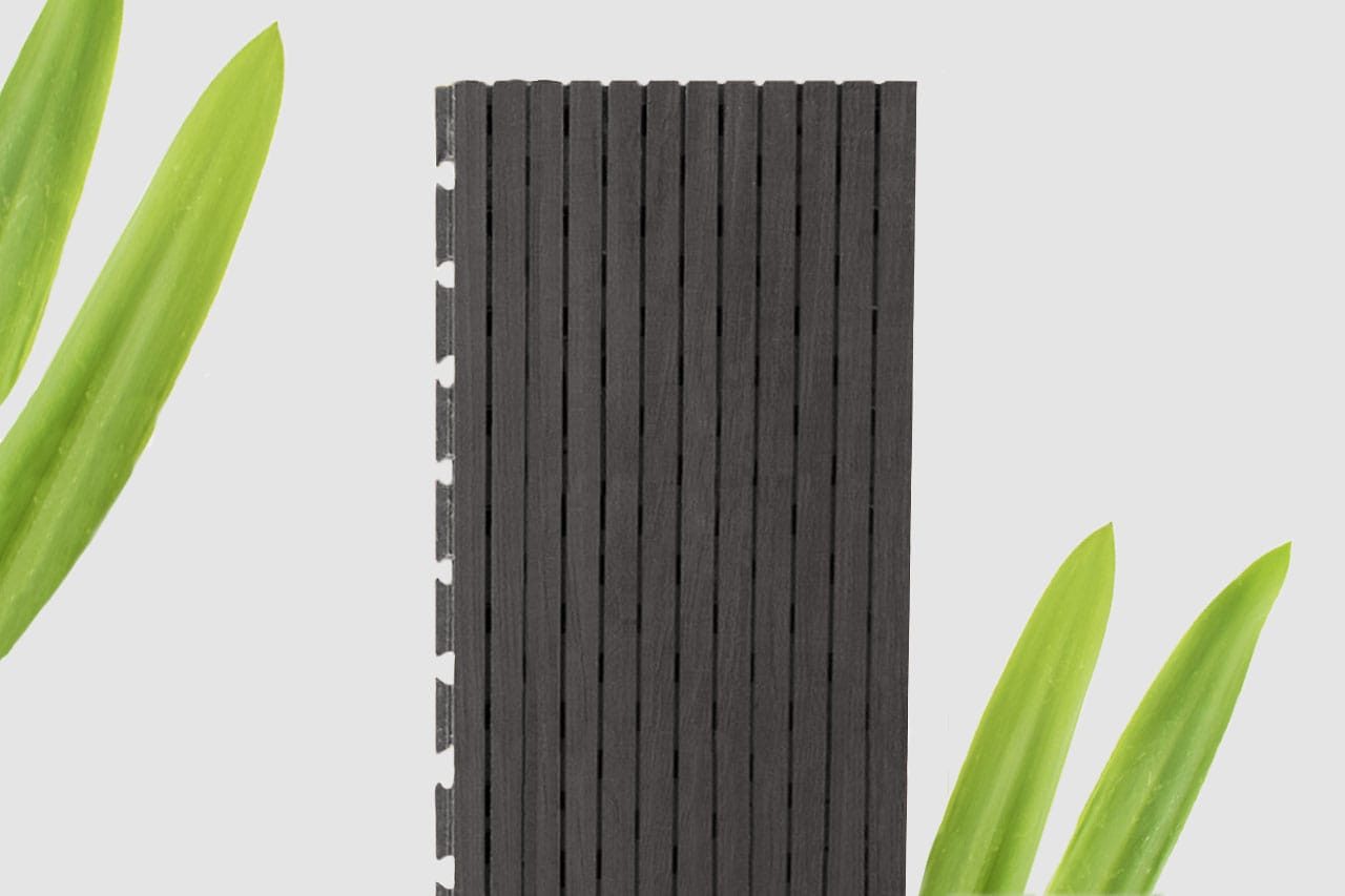 A vertical black slatted panel is centered against a white background, with green leaves in the top left and bottom right corners.