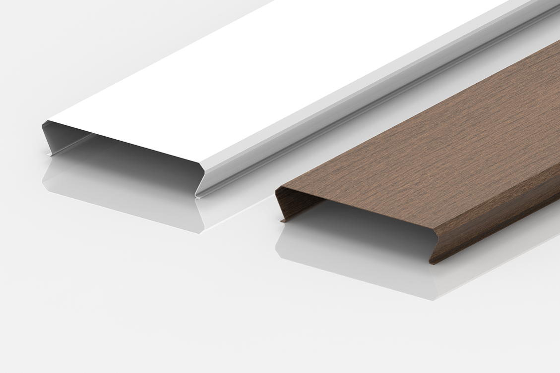 Two rectangular metal or plastic trim pieces are shown side by side on a white surface; one is white and the other has a brown wood-like finish. Both have a C-shaped cross-section.