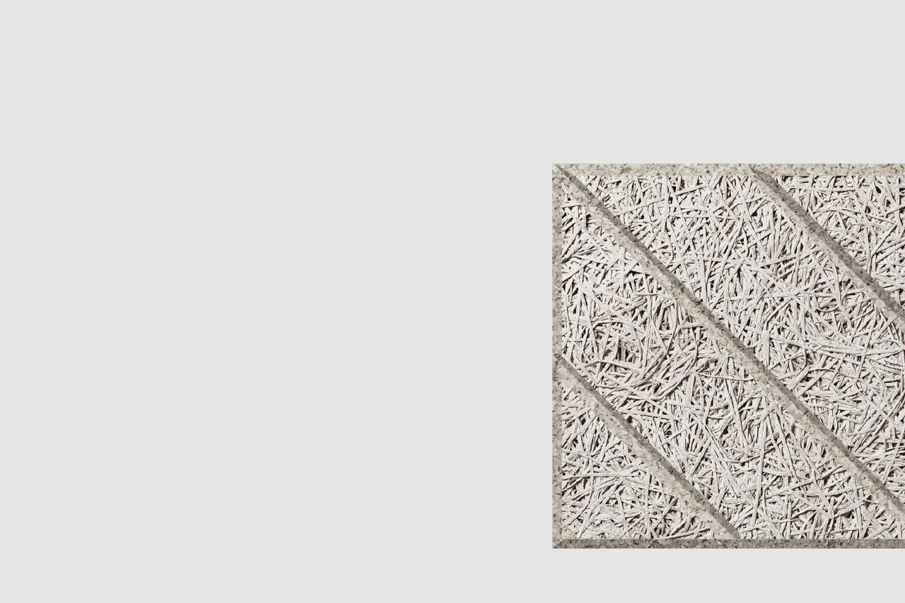 A square, textured panel with a woven, straw-like surface and three diagonal bands, set against a plain light gray background. The panel is positioned in the lower right corner of the image.