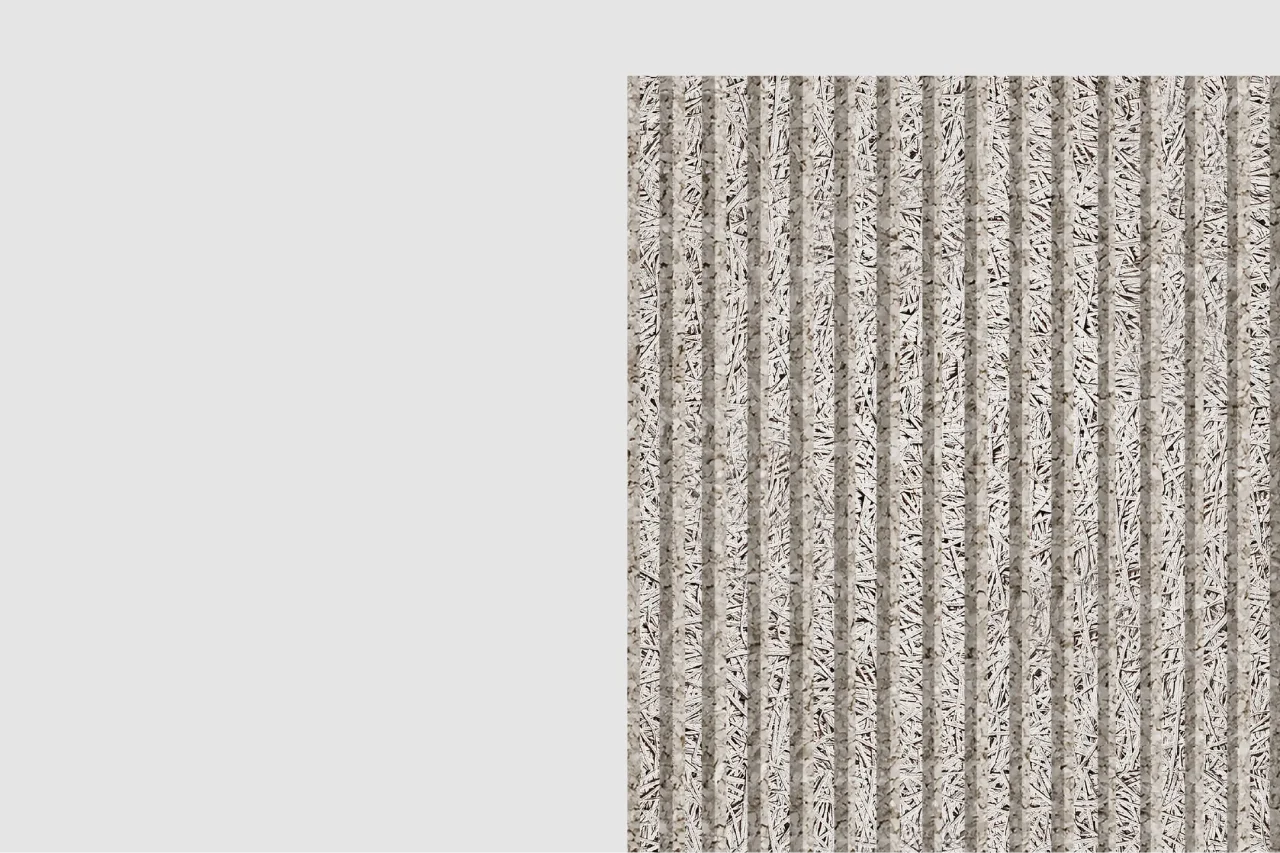A rectangular panel with a vertically ridged surface in gray and beige tones stands against a plain light gray background, occupying the right side of the image.